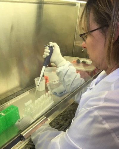 Scientist working with a pipette.