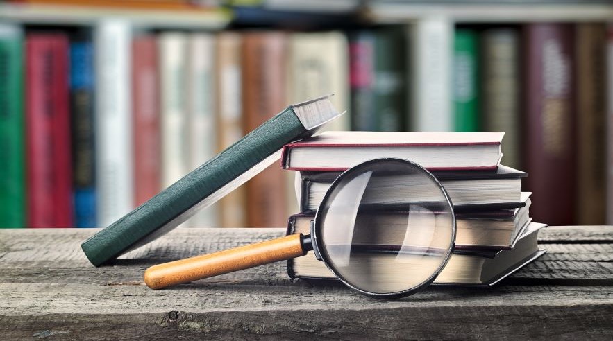 Books and magnifying glass