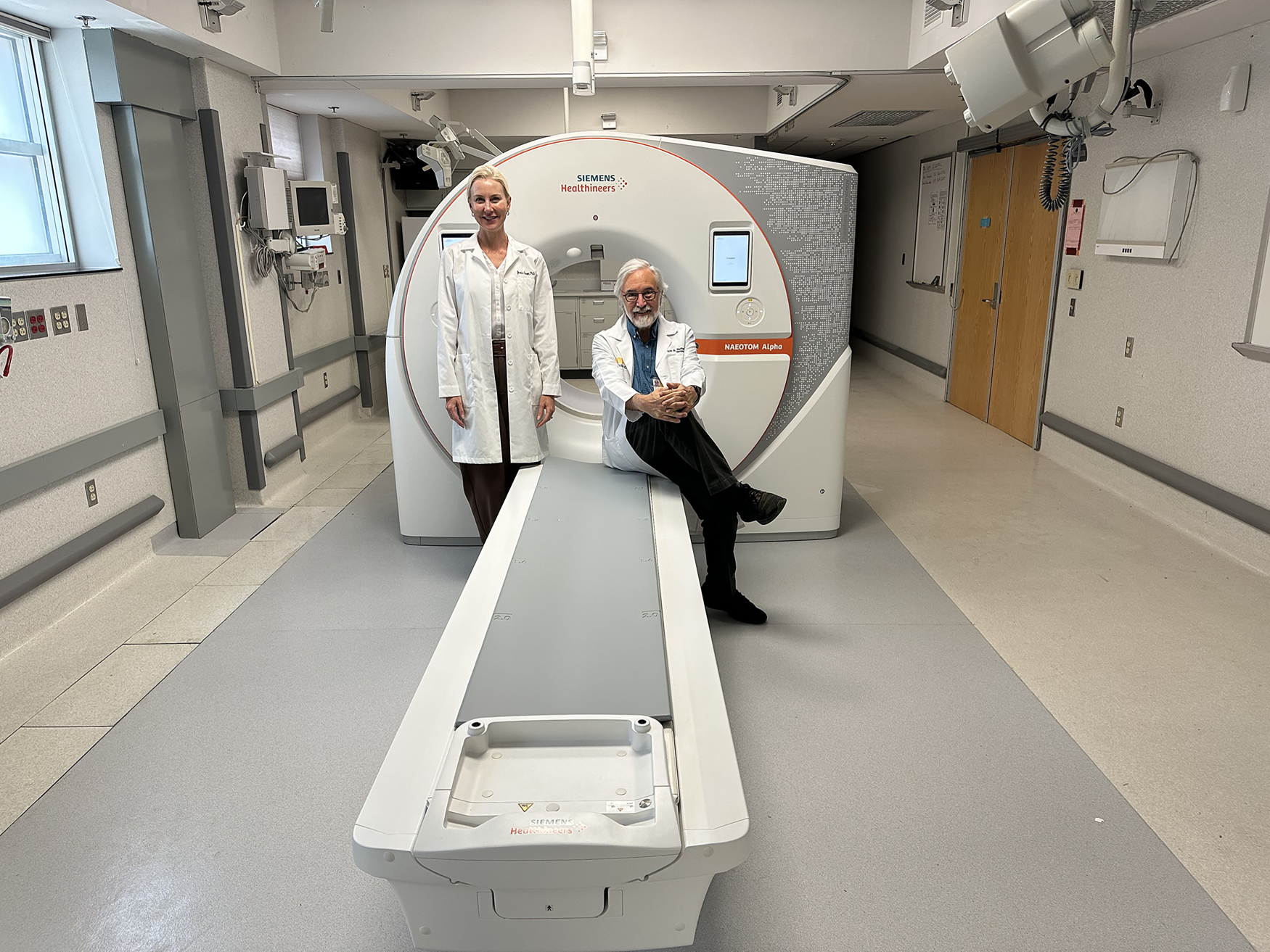 Eric Hoffman and Jessica Sieren in front of a PCD-CT scanner.