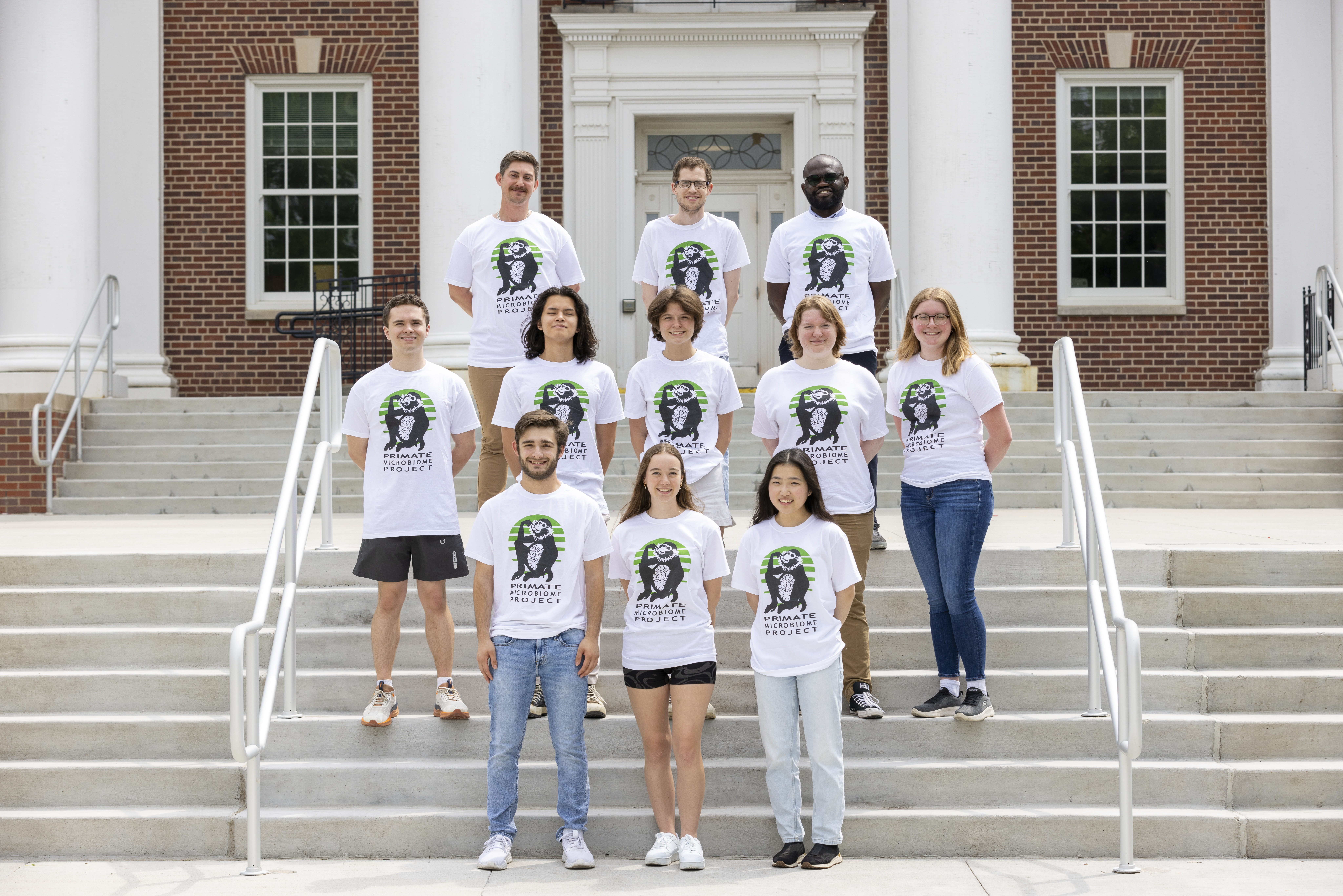 A group of researchers standing in front of a building
