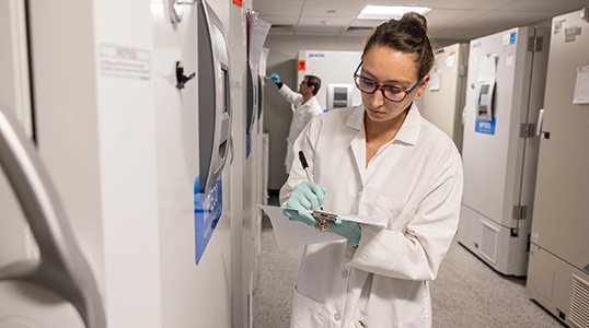 A scientist taking notes in a laboratory