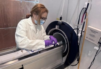 A researcher using the 7-Tesla Bruker Biospec 70/30 magnetic resonance imaging scanner.