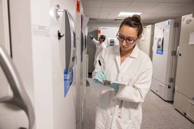 A scientist taking notes in a laboratory
